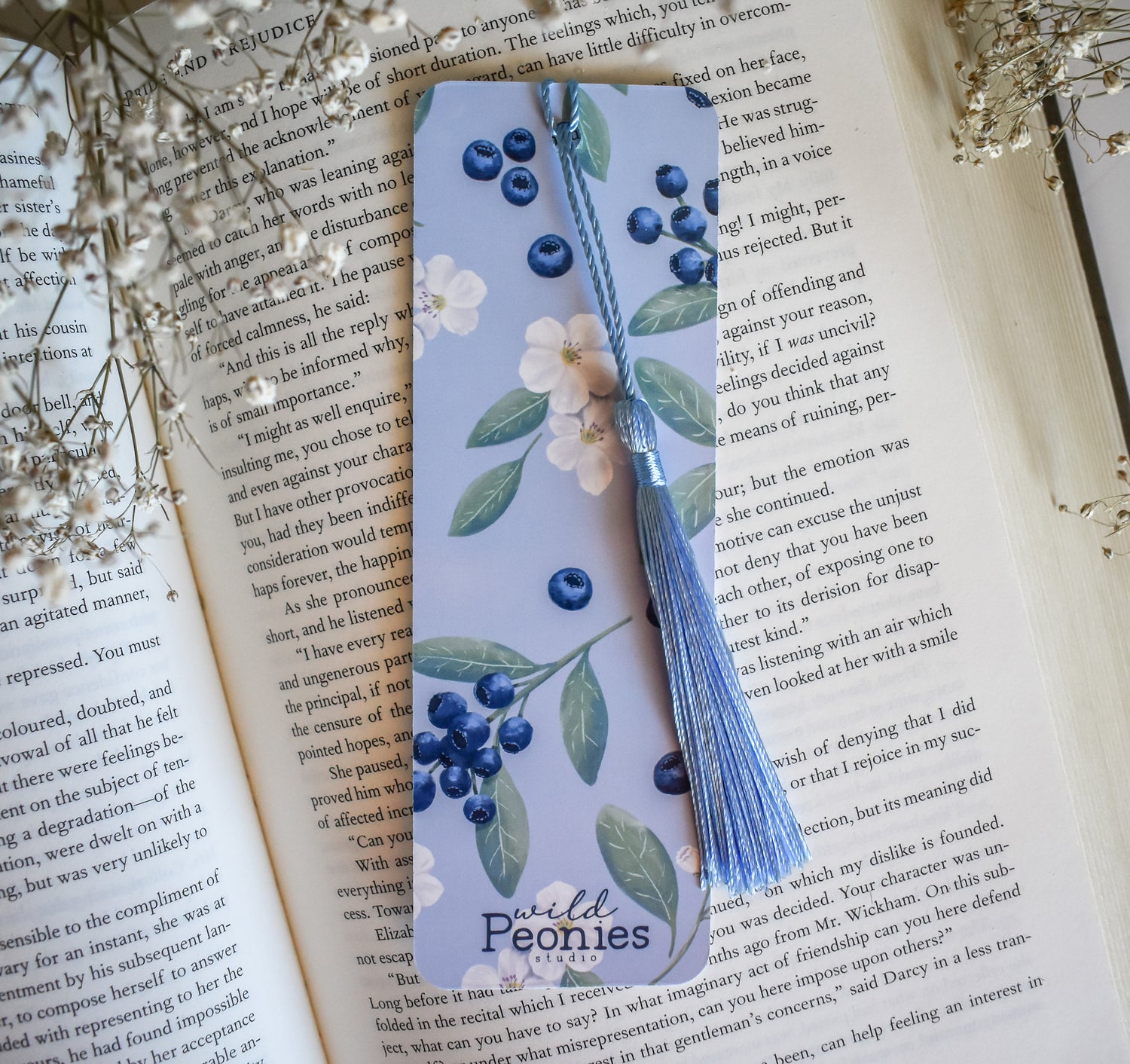 Bookmark with blueberry floral artwork design printed on both sides and a blue tassel