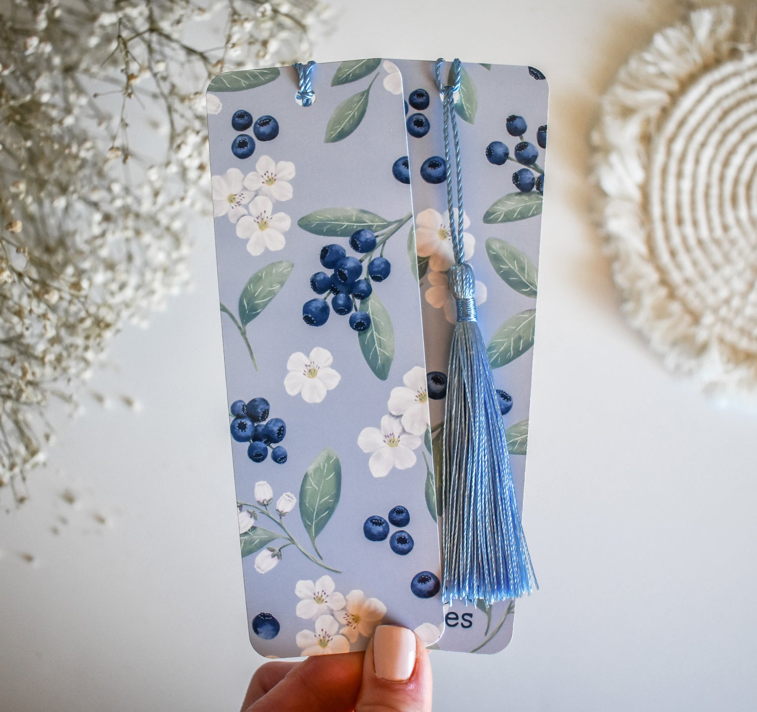 Bookmark with blueberry floral artwork design printed on both sides and a blue tassel