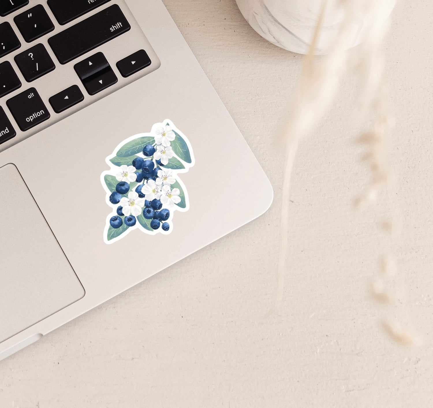 A bunch of blueberries with white flowers vinyl laptop sticker