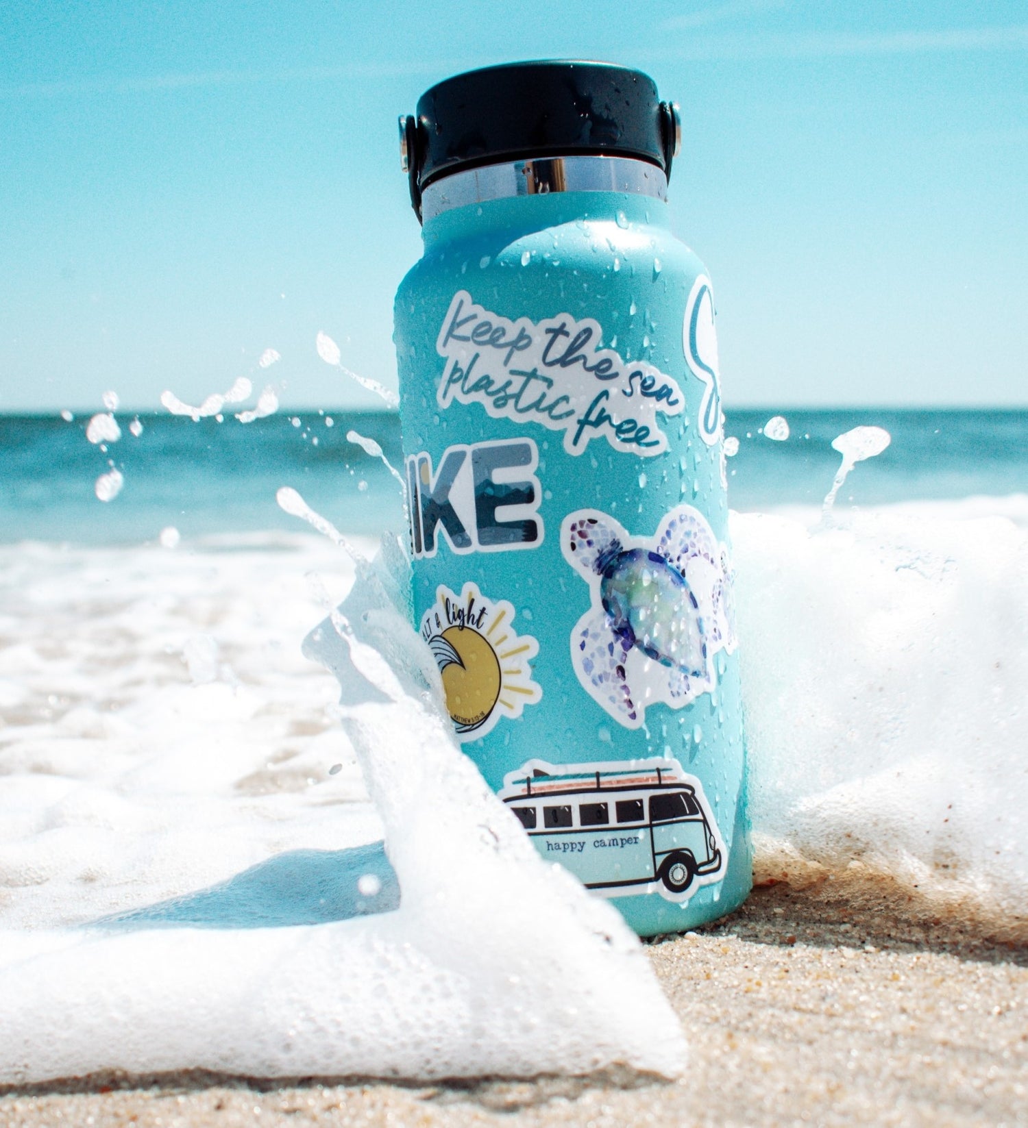Durable, UV resistant, and waterproof, these stickers are printed on a premium vinyl. The vinyl decals are placed on a hydro flask water bottle at the beach with the ocean splashing over them.