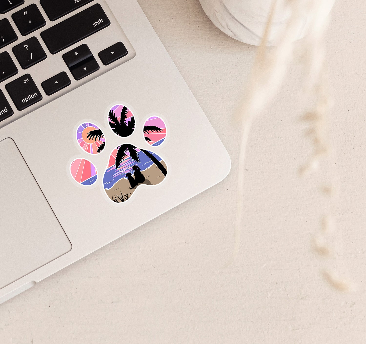 Dog paw print laptop sticker of a girl and her dog watching the sunset at the beach