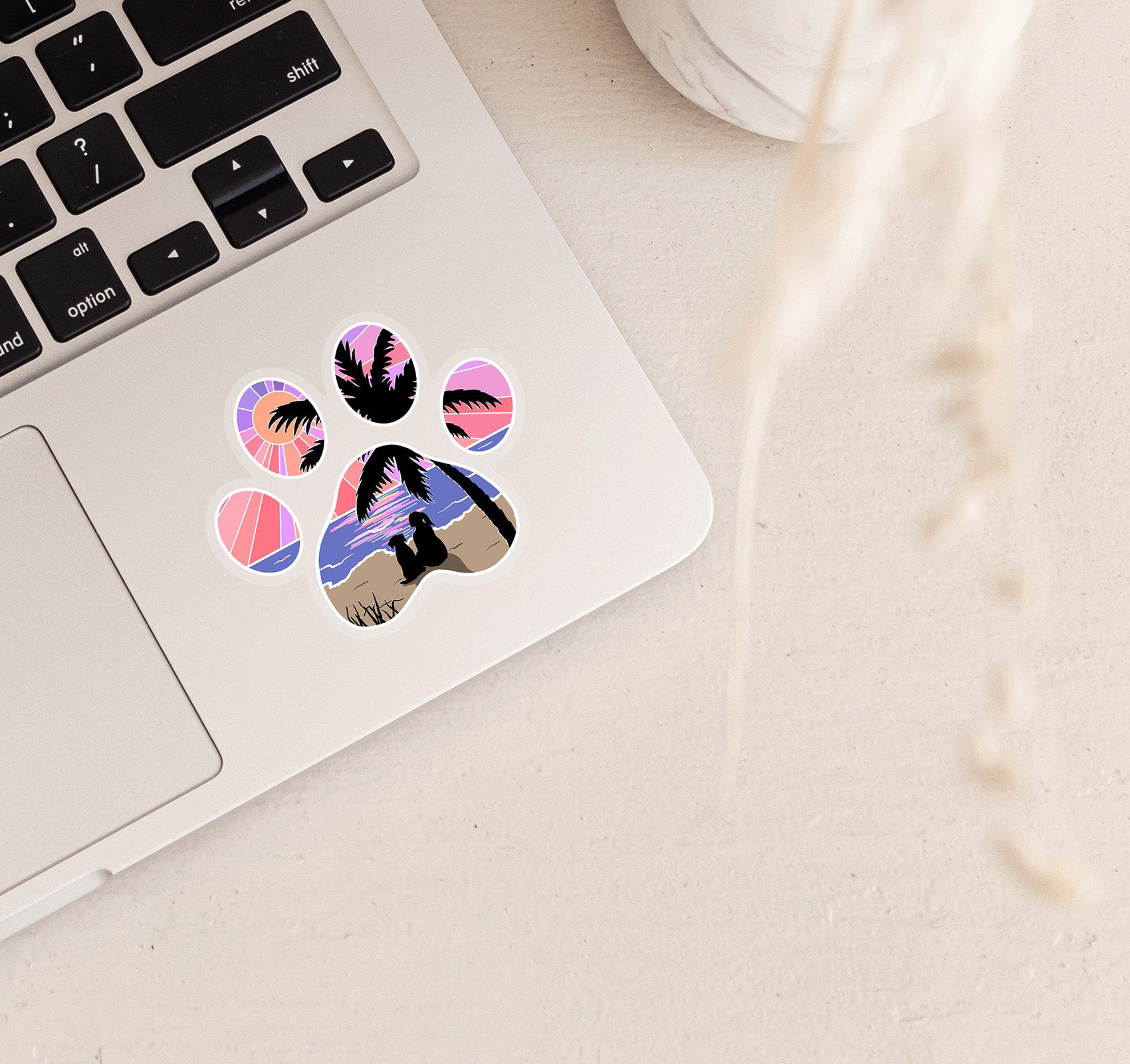 Dog paw print laptop sticker of a girl and her dog watching the sunset at the beach