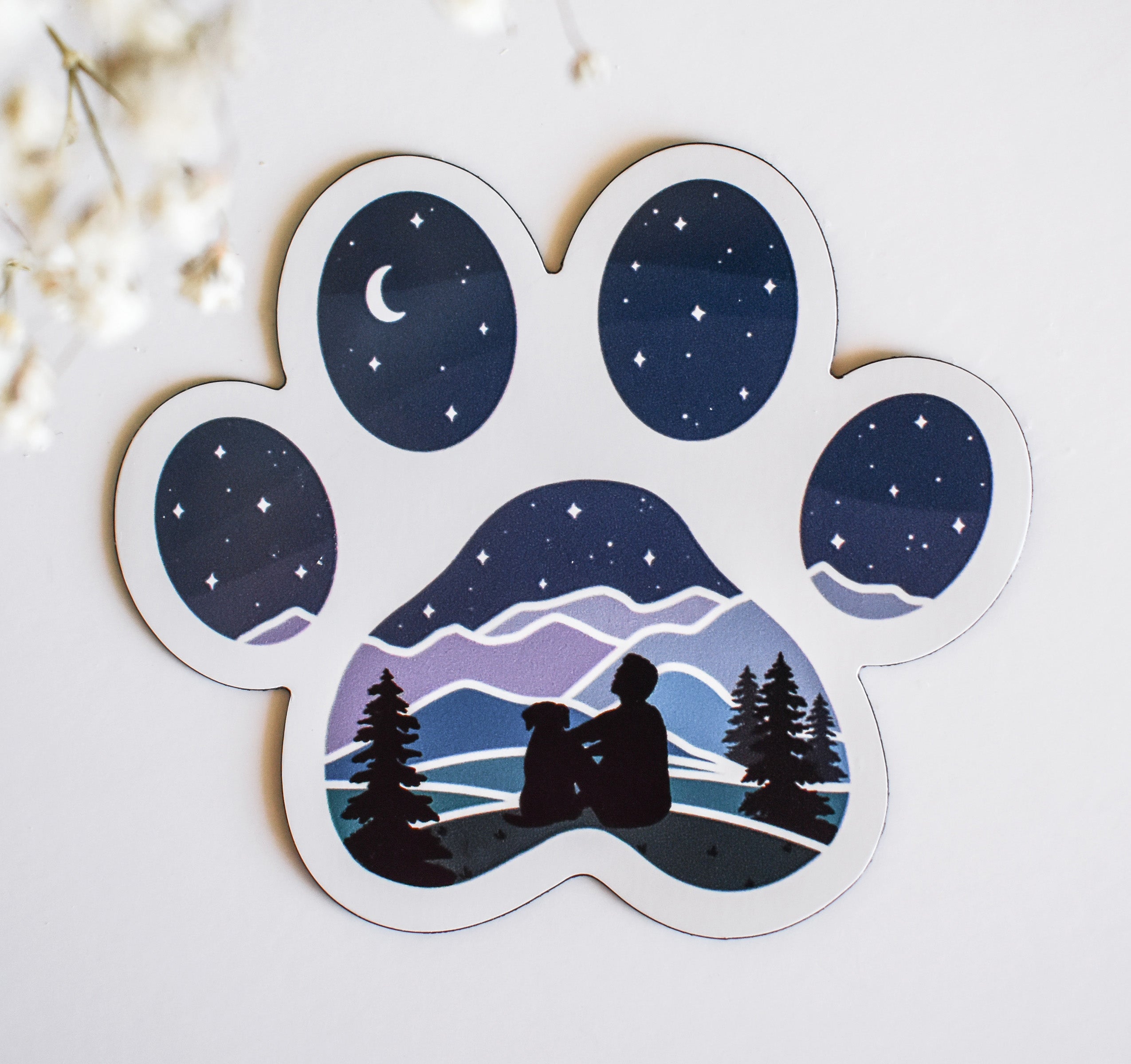 Man and his dog stargazing over the mountains refrigerator magnet in the shape of a dog paw print