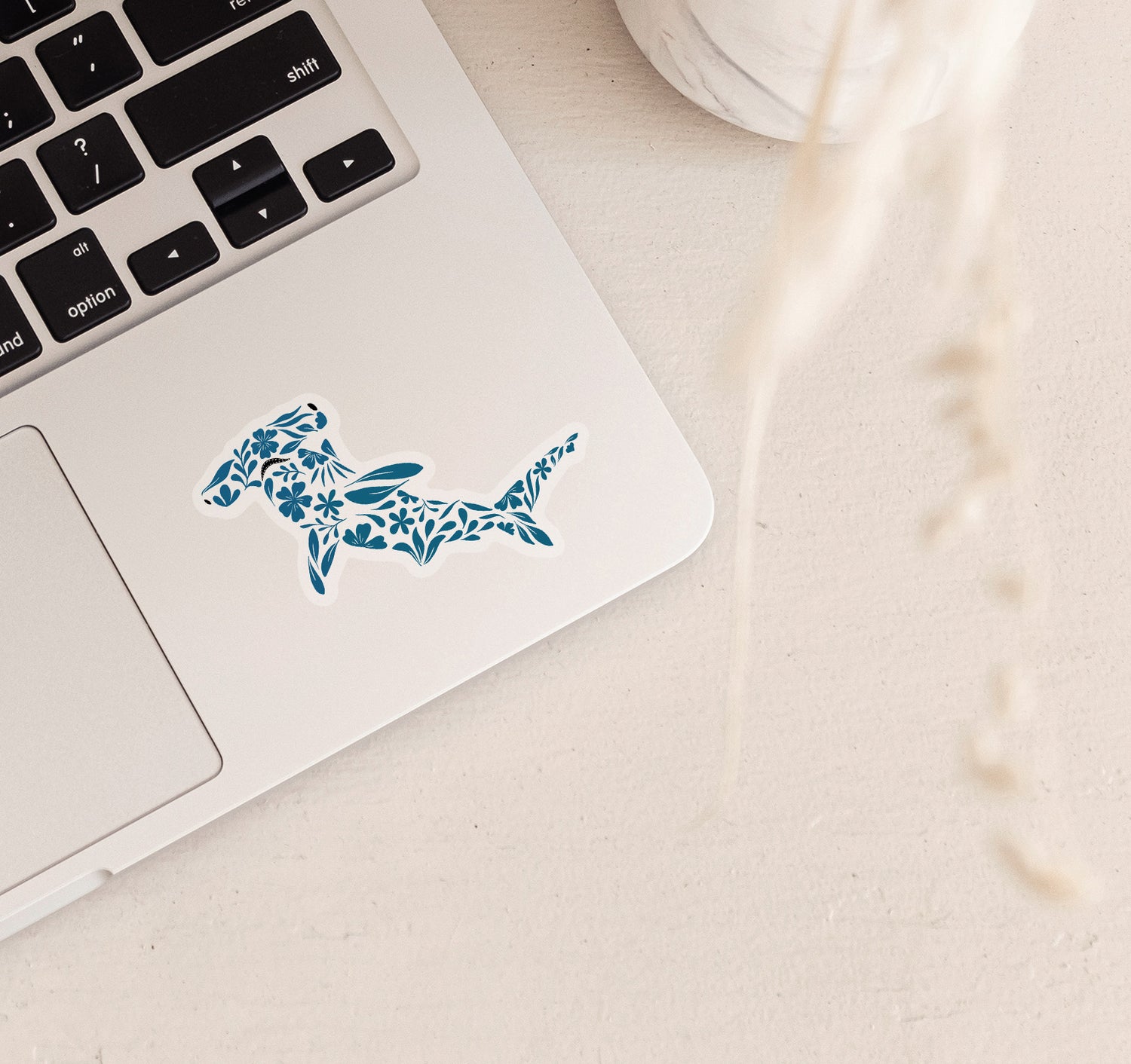 Hammerhead shark laptop sticker created with turquoise flowers and leaves pattern
