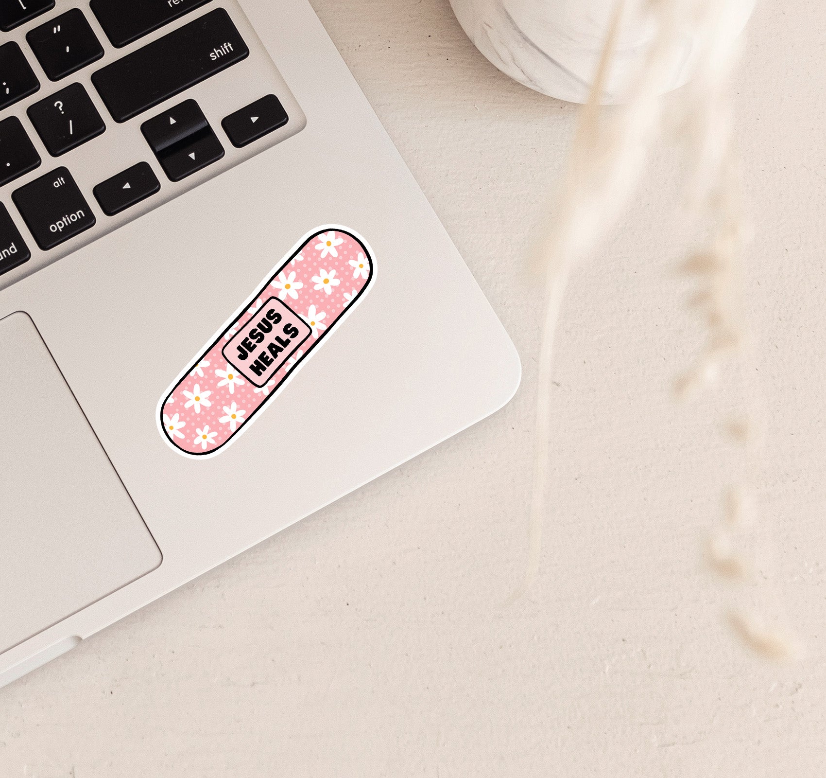 Jesus heals vinyl laptop sticker on a band aid design