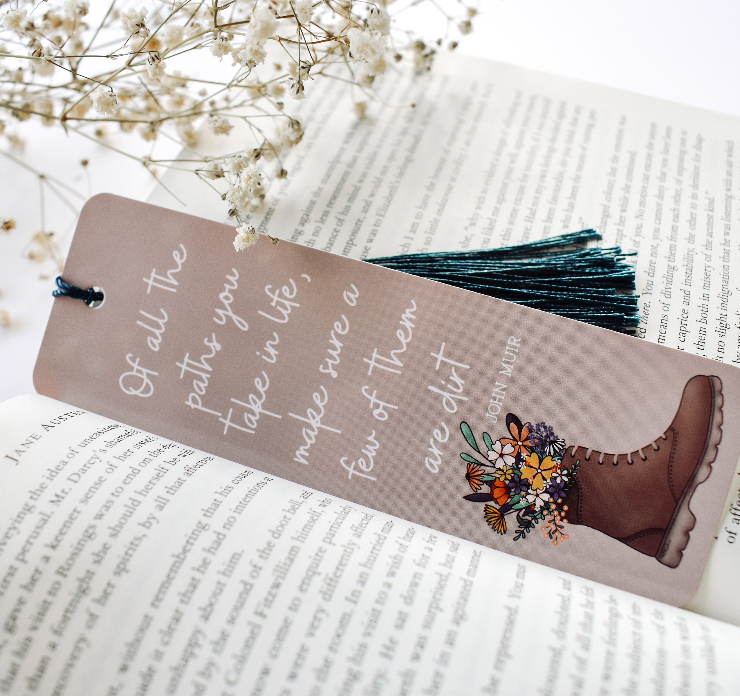 Bookmark with the John Muir quote "Of all the paths you take in life, make sure a few of them are dirt" and a hiking boot with flowers design