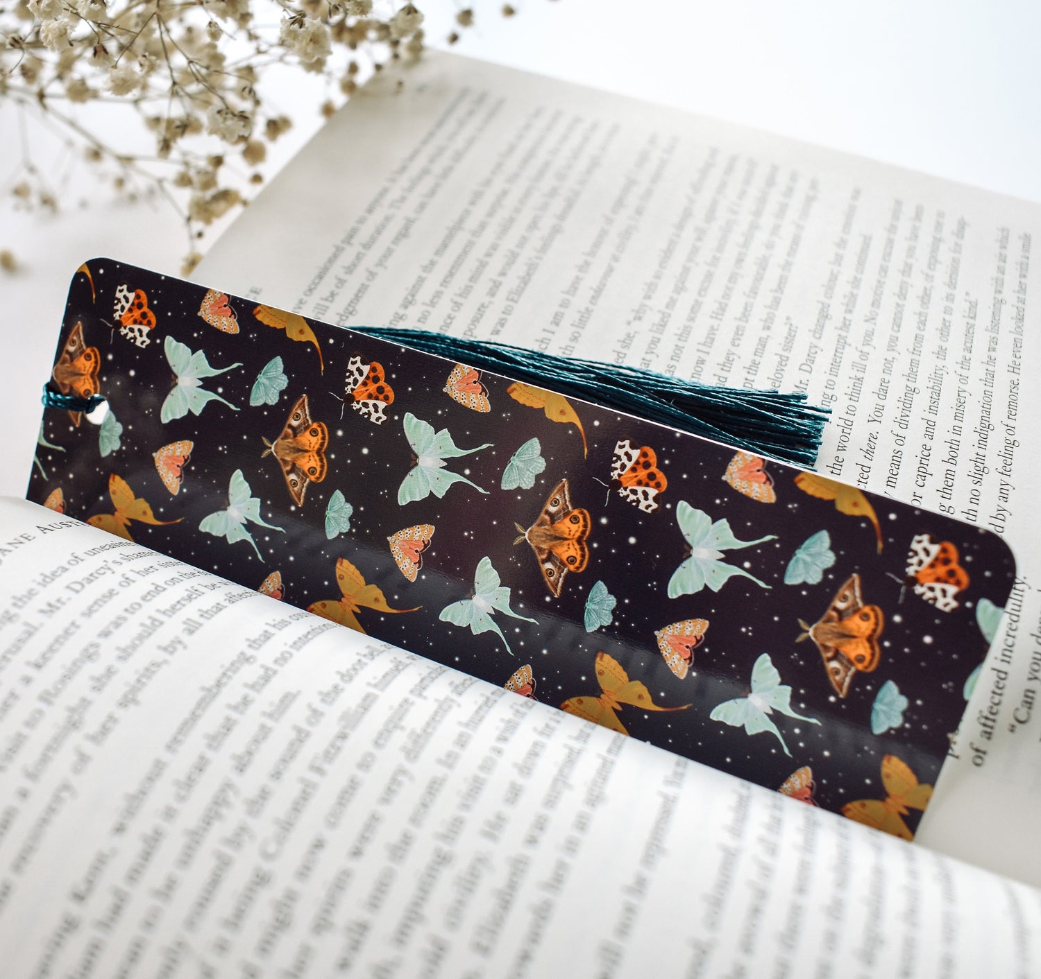 Bookmark with a pattern of moths, including the Emperor Moth, Luna Moth, Comet Moth, Emerald Moth, Bella Moth, and Garden Tiger Moth