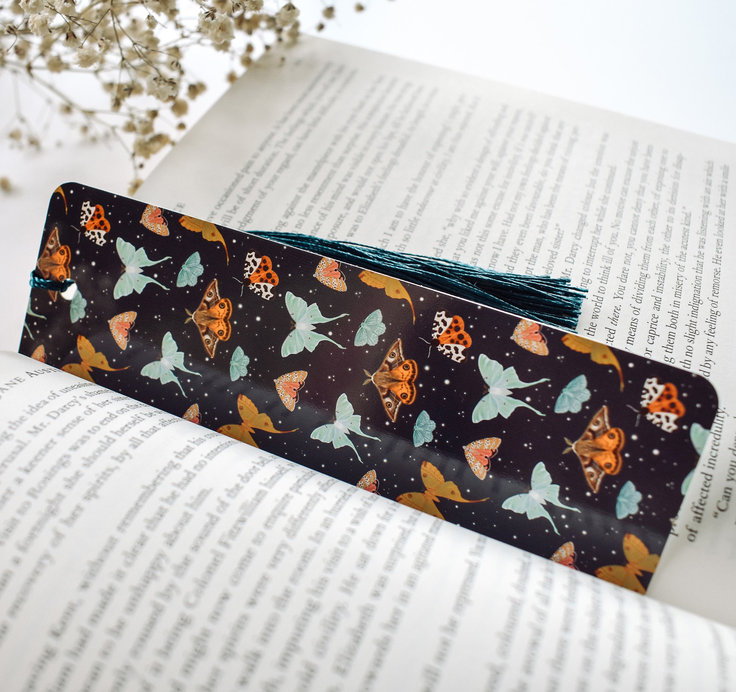 Bookmark with a pattern of moths, including the Emperor Moth, Luna Moth, Comet Moth, Emerald Moth, Bella Moth, and Garden Tiger Moth