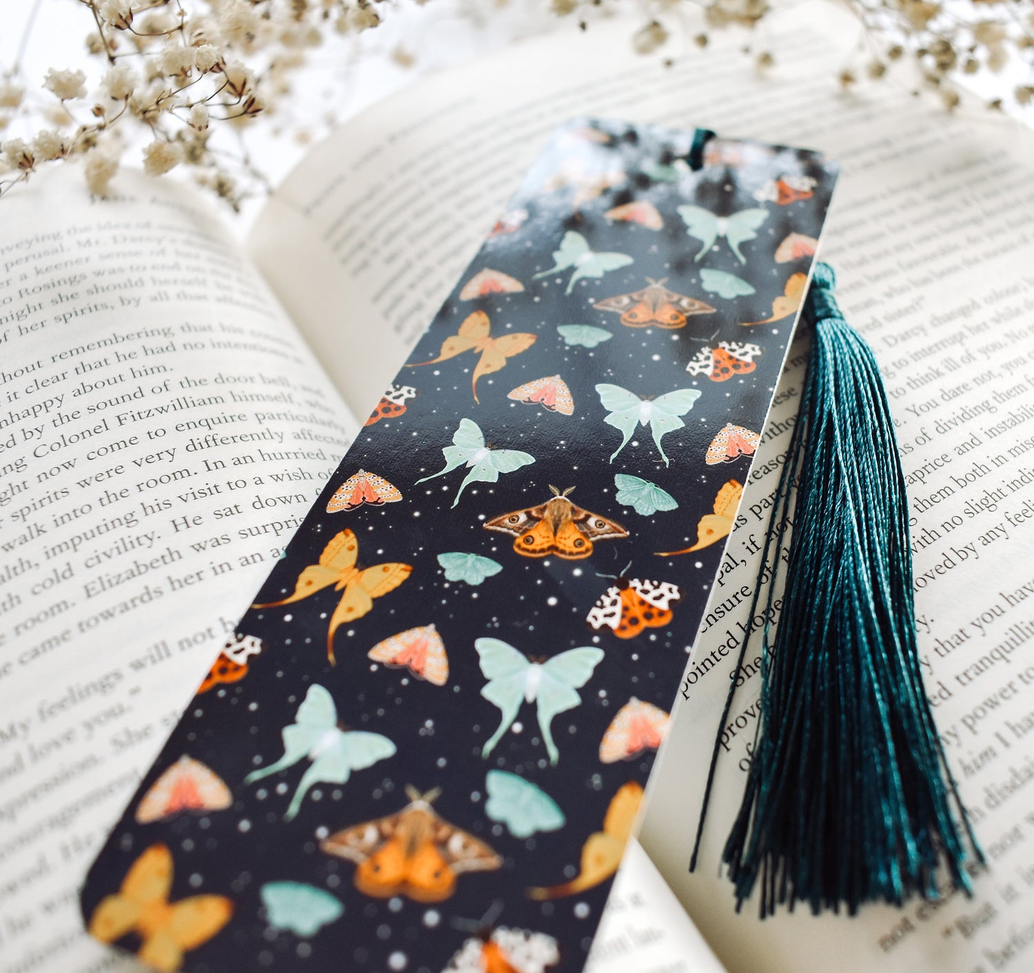 Bookmark with a pattern of moths, including the Emperor Moth, Luna Moth, Comet Moth, Emerald Moth, Bella Moth, and Garden Tiger Moth