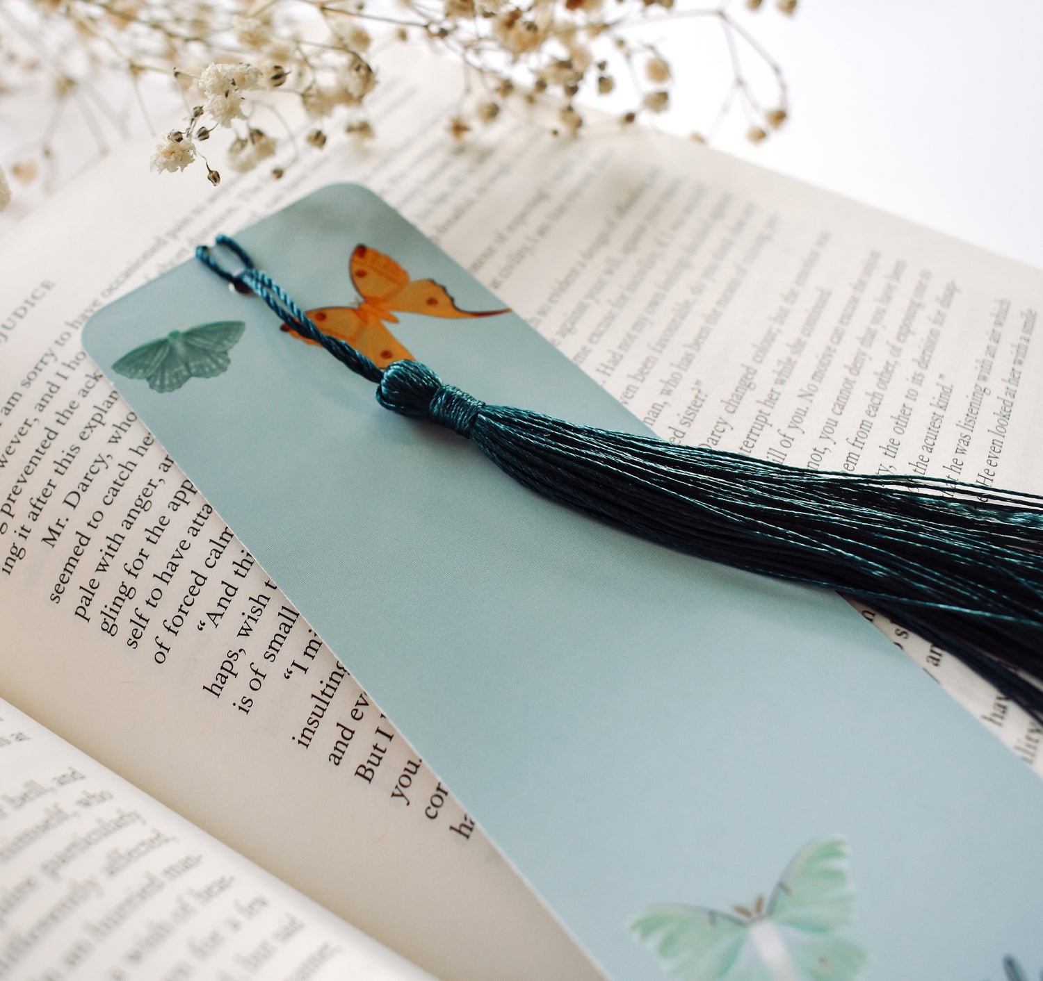 Bookmark with a pattern of moths, including the Emperor Moth, Luna Moth, Comet Moth, Emerald Moth, Bella Moth, and Garden Tiger Moth