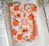 Bookmark with peach artwork design printed on both sides and a pink tassel