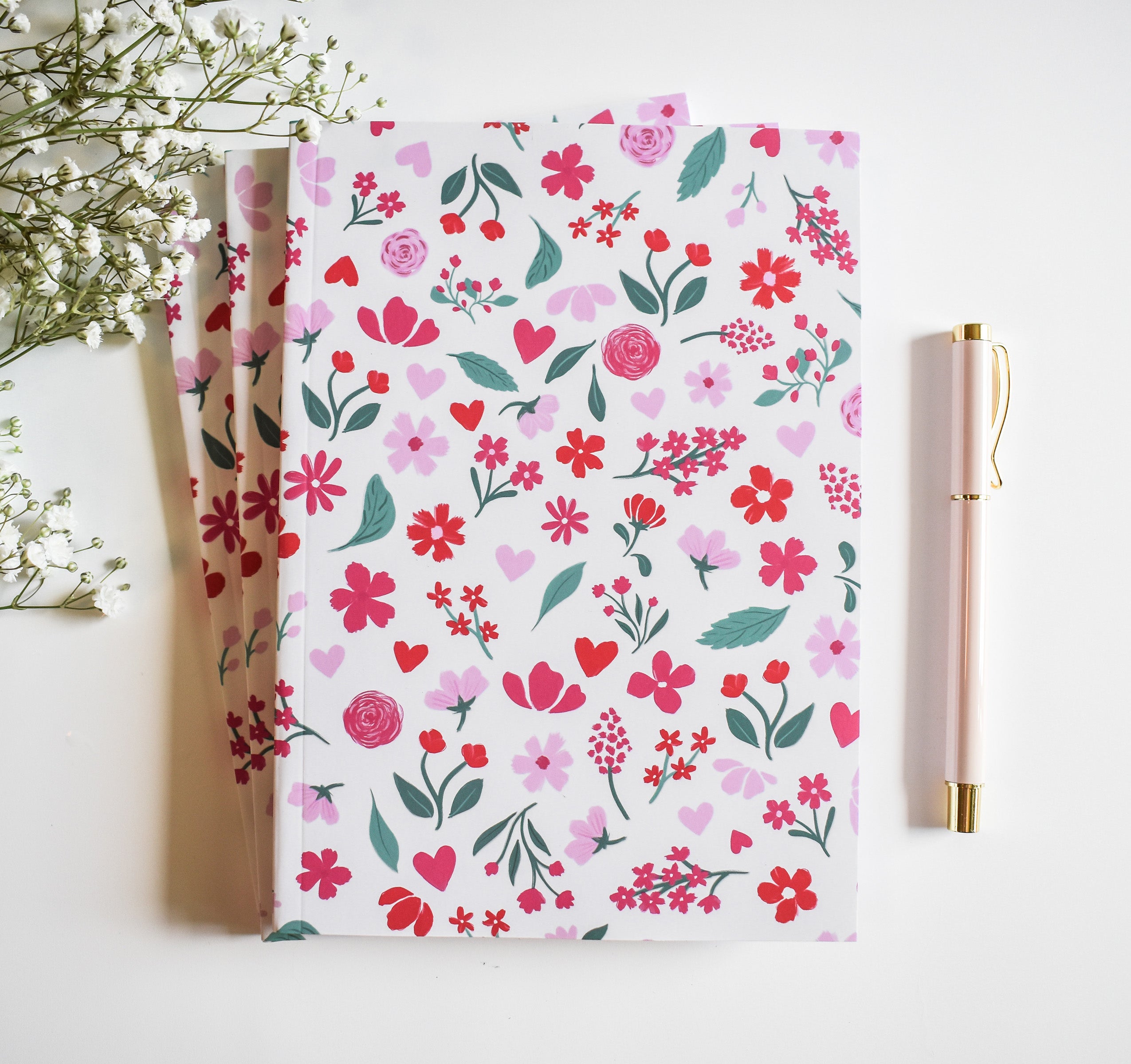 Journal with pink and red flowers on a light pink background
