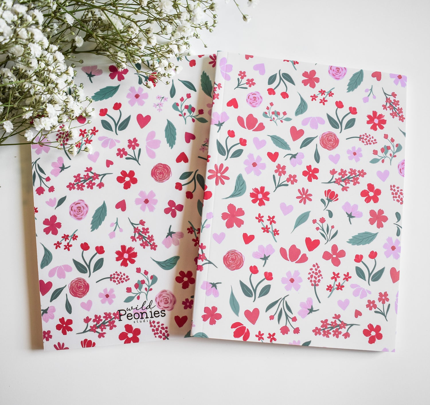 Journal with pink and red flowers on a light pink background