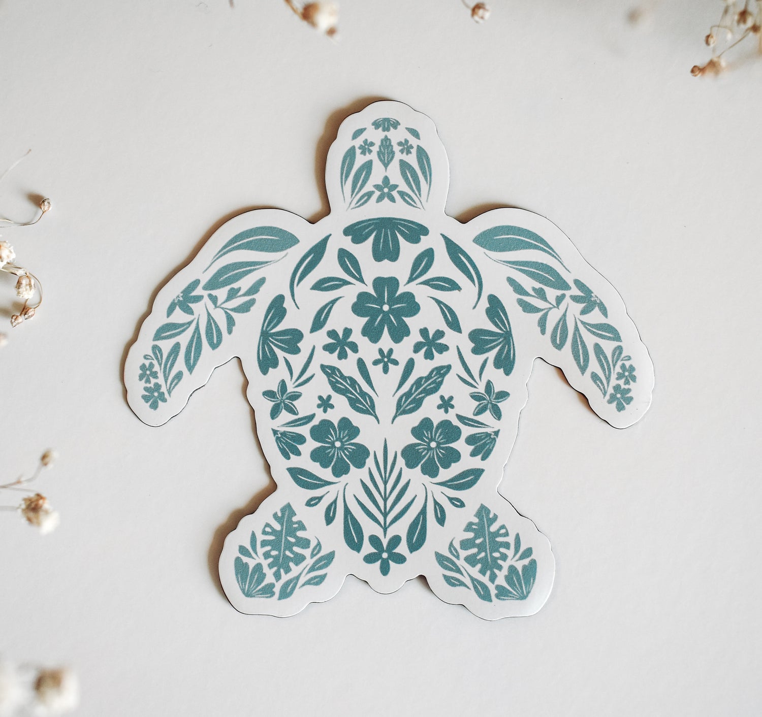 Decorative sea turtle magnet designed with pale teal flowers