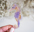 Seahorse sticker in tan, orange, and purple