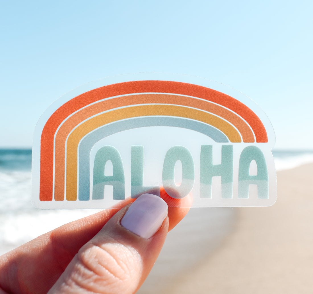 Clear Hawaiian aloha vinyl sticker with a rainbow