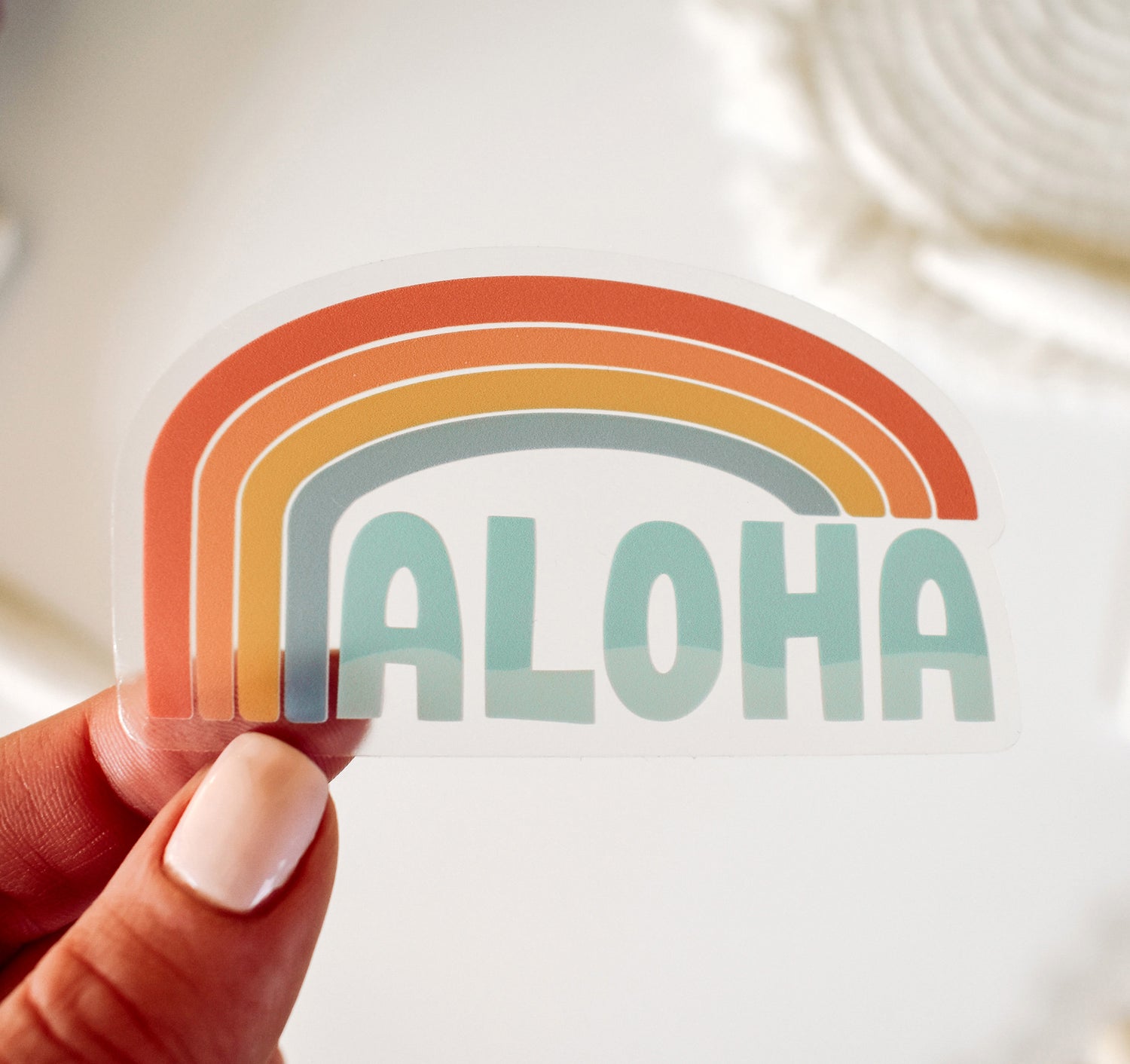 Clear Hawaiian aloha vinyl sticker with a rainbow