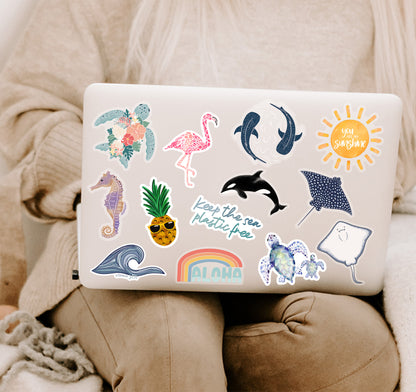 A  laptop covered in colorful ocean-themed stickers
