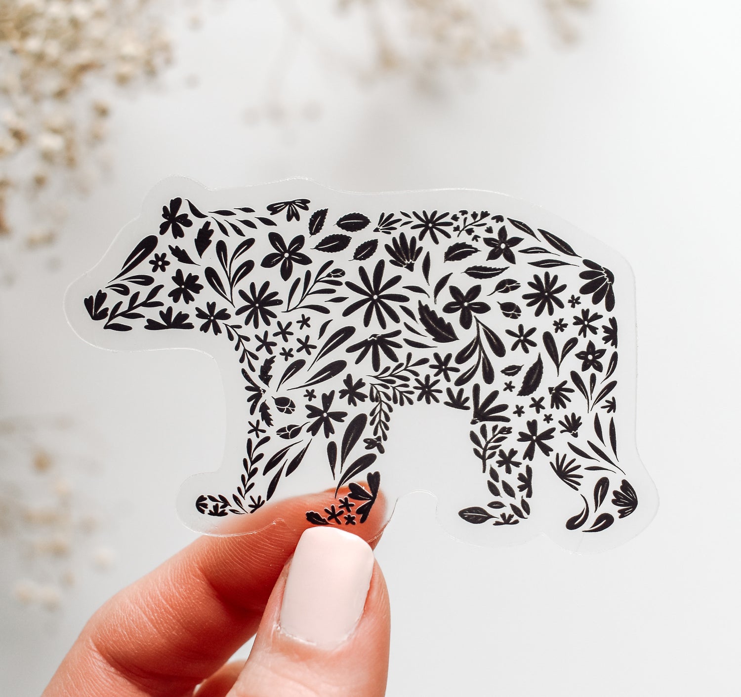 Decorative bear sticker on clear vinyl with black floral patterns