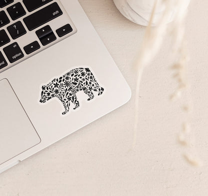 Decorative bear clear vinyl sticker with black floral patterns on a laptop