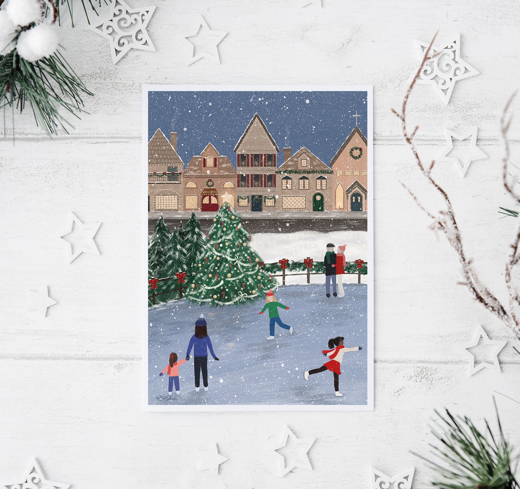 Ice skaters and a Christmas village in the snow art print