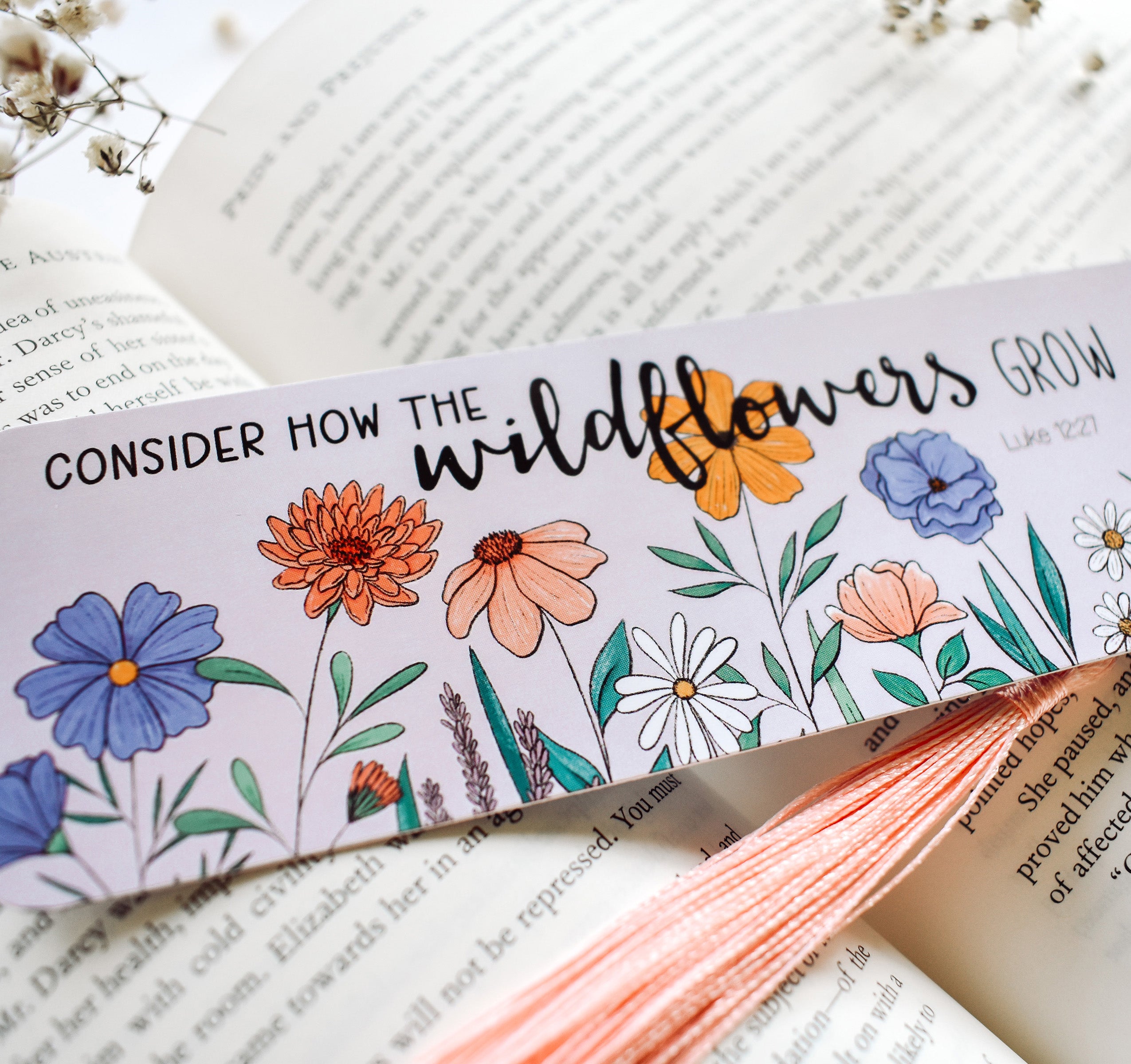 Christian Luke 12:27 Bible verse bookmark with flowers and a pink tassel