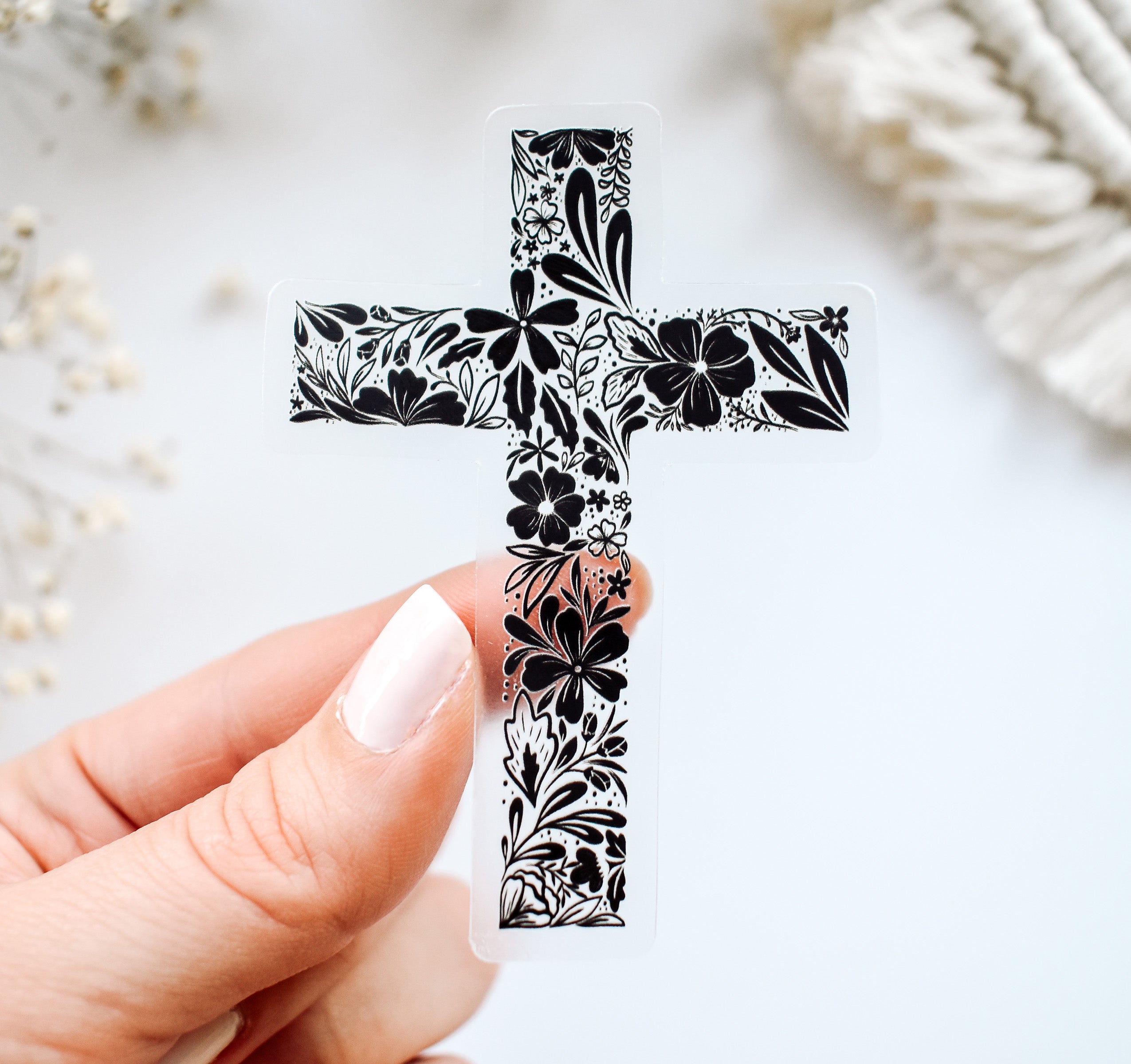 Christian cross with black botanical flowers on a clear vinyl sticker