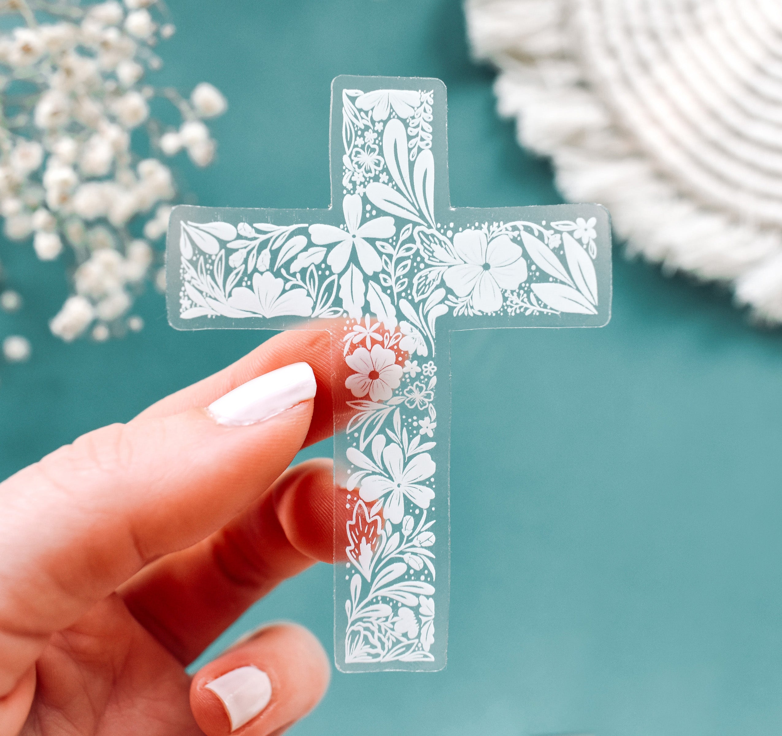 Christian cross with white botanical flowers on a clear vinyl sticker
