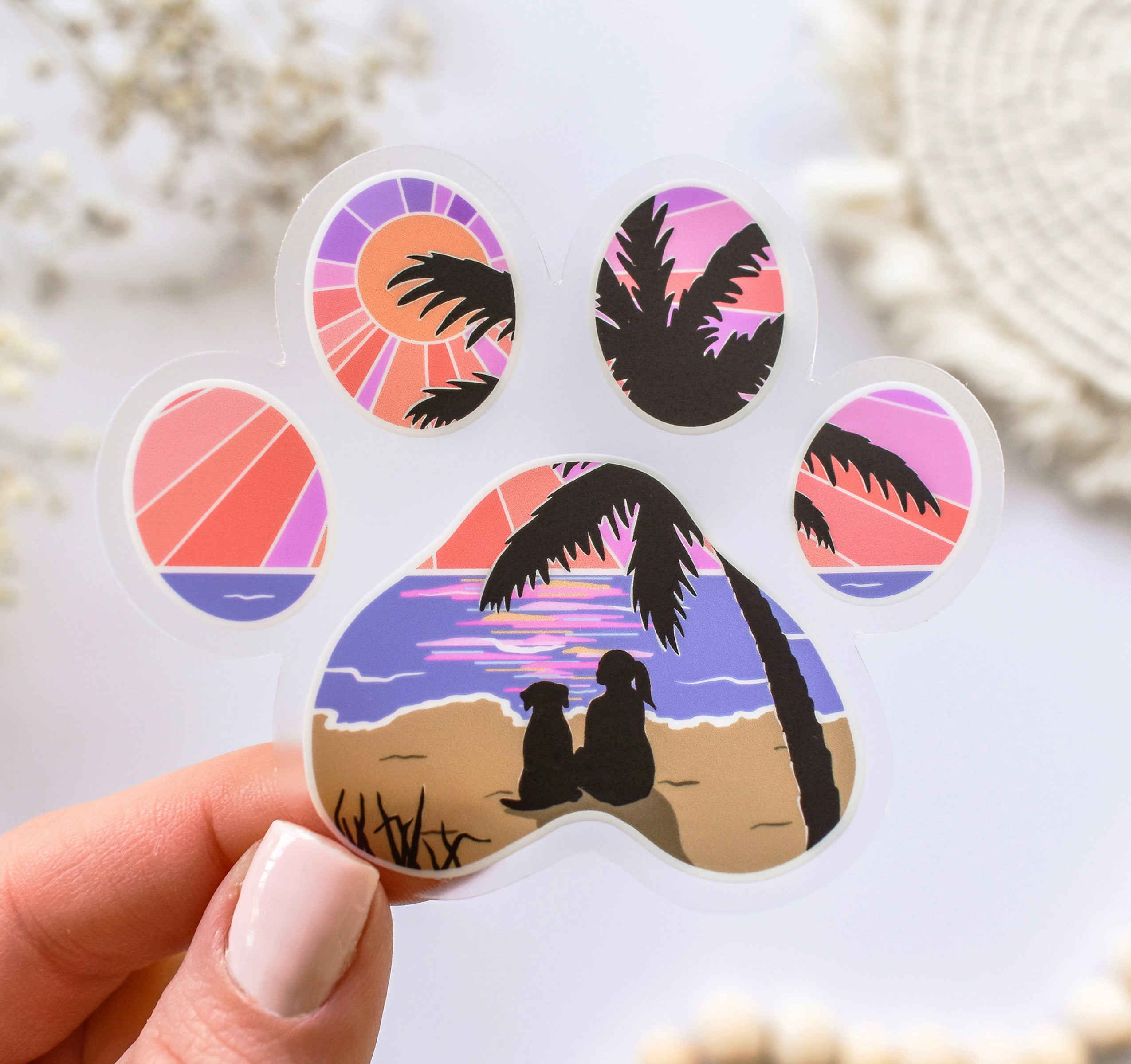 Dog paw print sticker of a girl and her dog watching the sunset at the beach