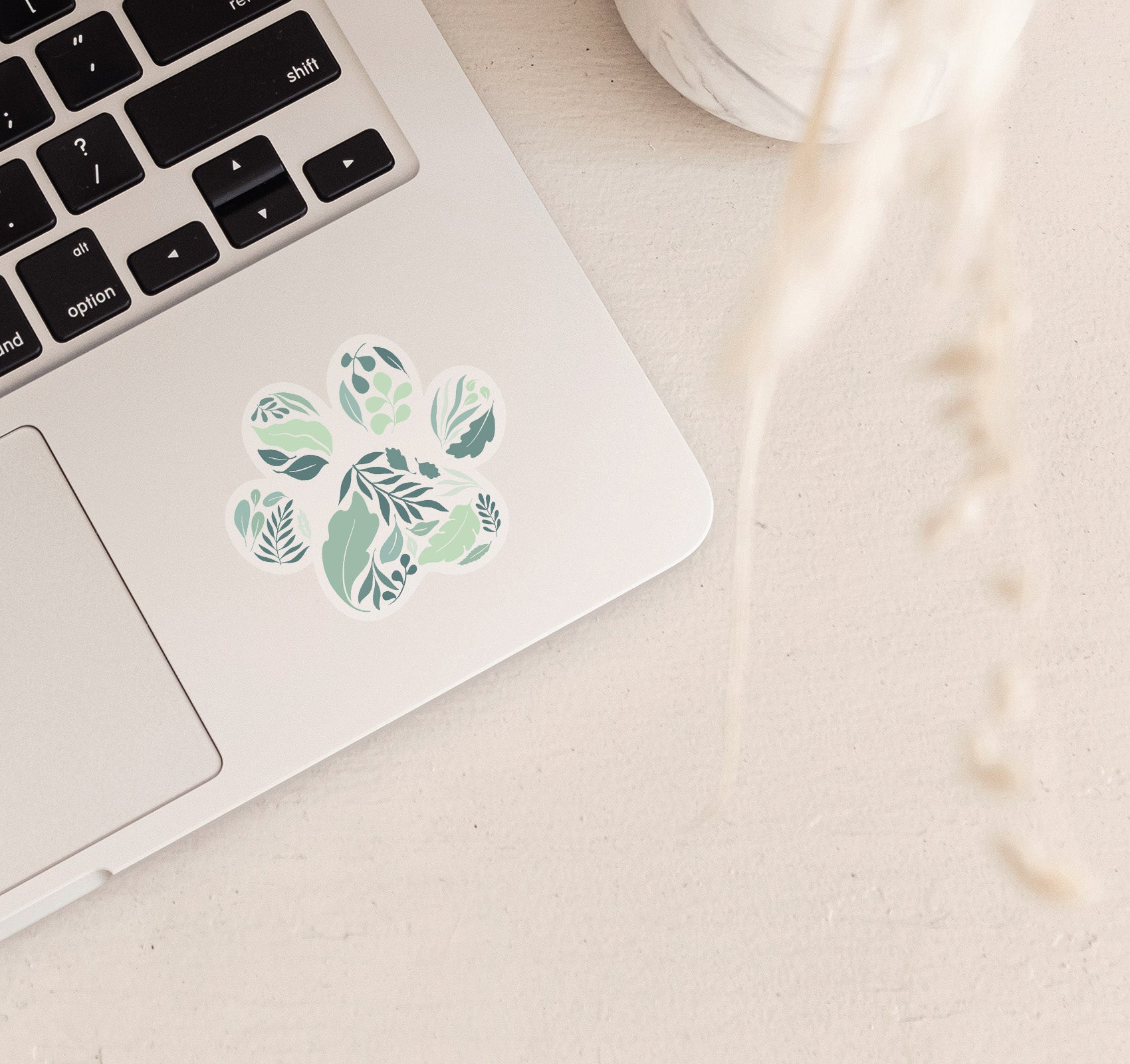 Leaves and nature sticker in the shape of a dog paw print