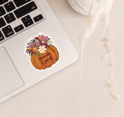 A die-cut sticker featuring a pumpkin with autumn flowers and the words &