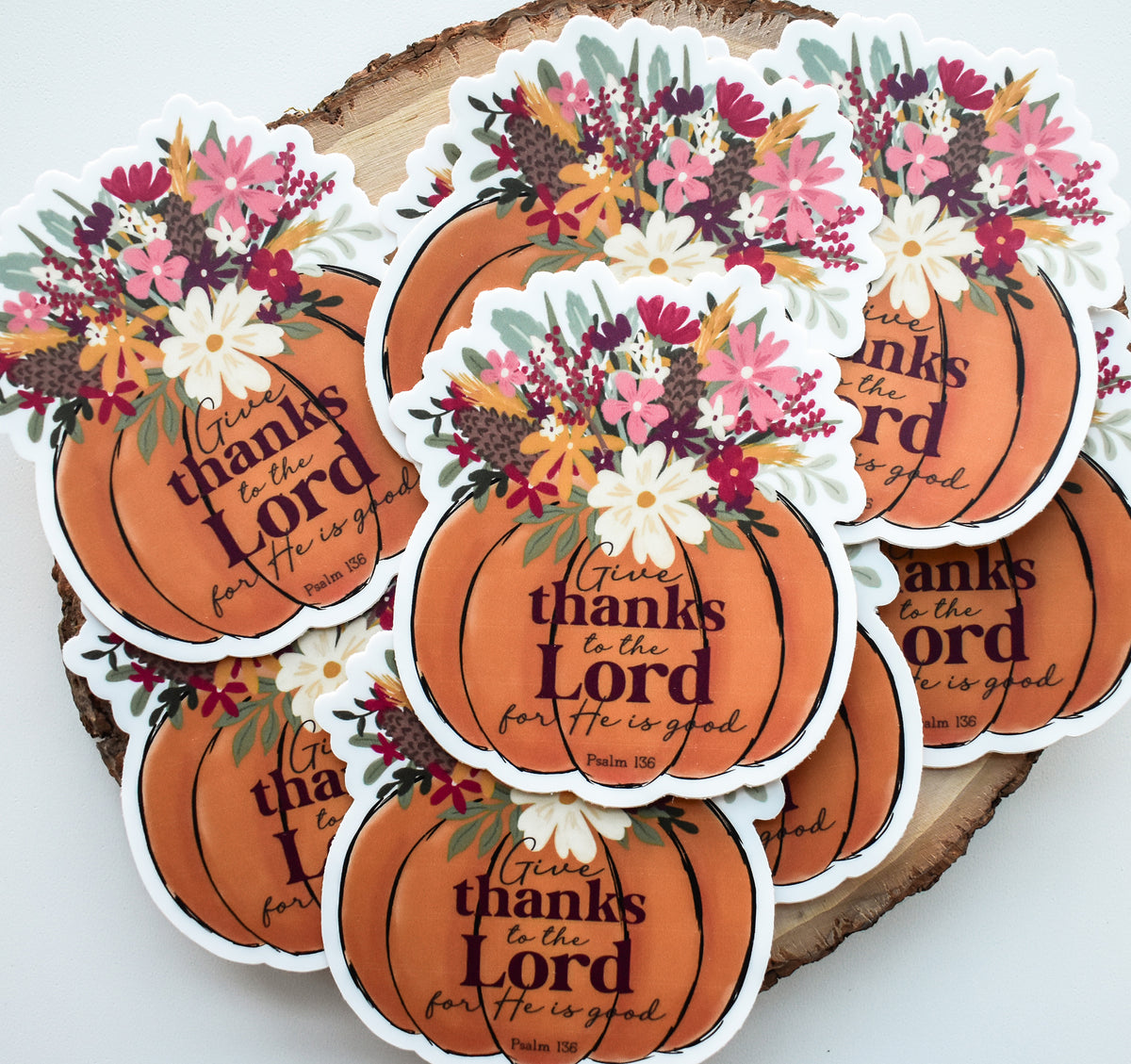 A set of die-cut sticker decals shaped like orange pumpkins, decorated with autumn floral bouquets and the printed message &