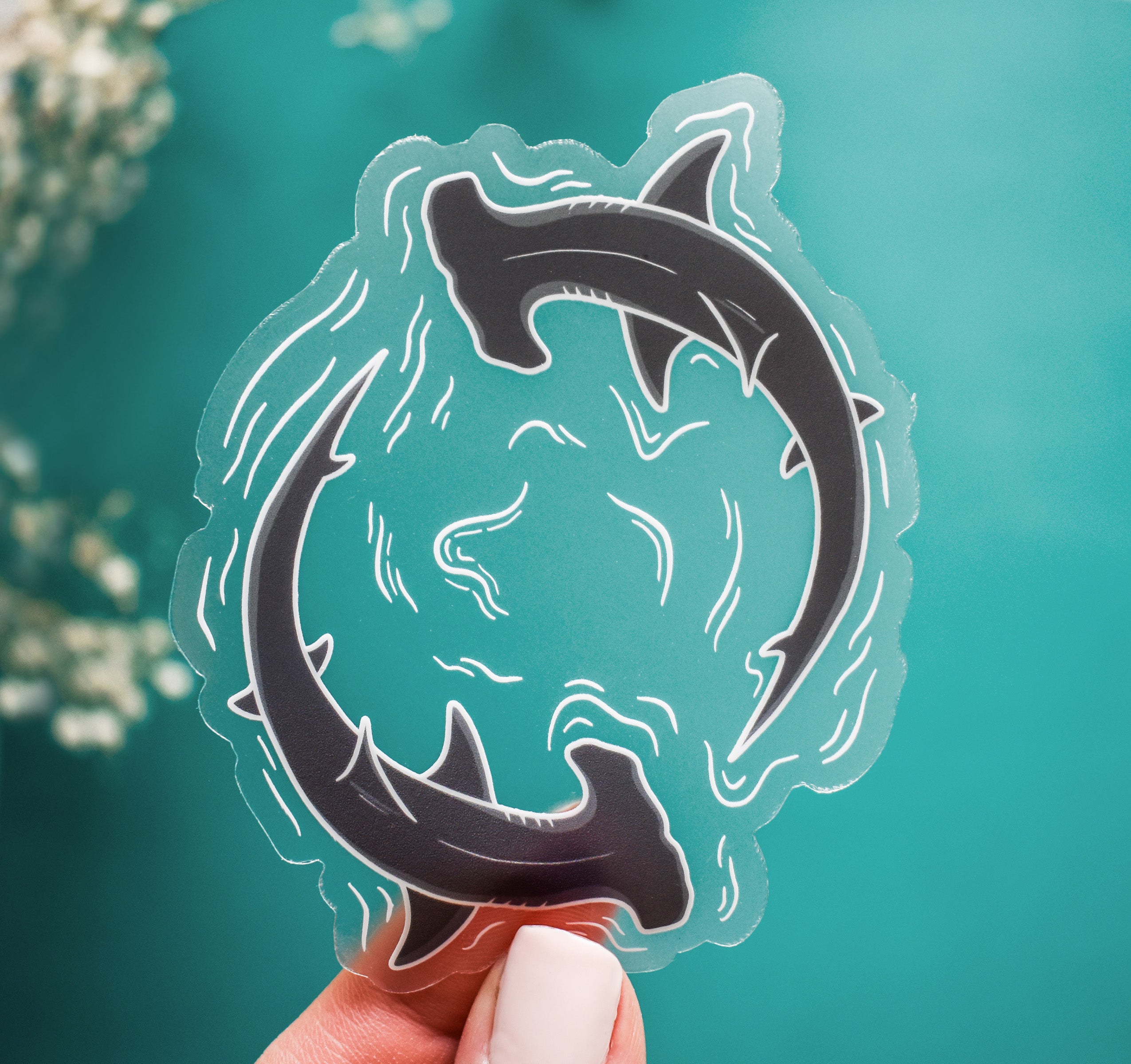 Clear vinyl sticker of two hammerhead sharks circling through water