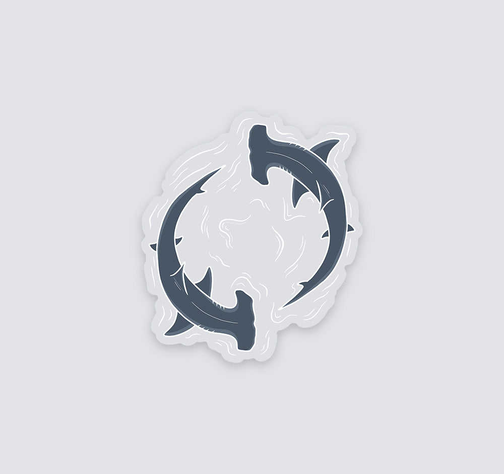 Clear vinyl sticker of two hammerhead sharks circling through water