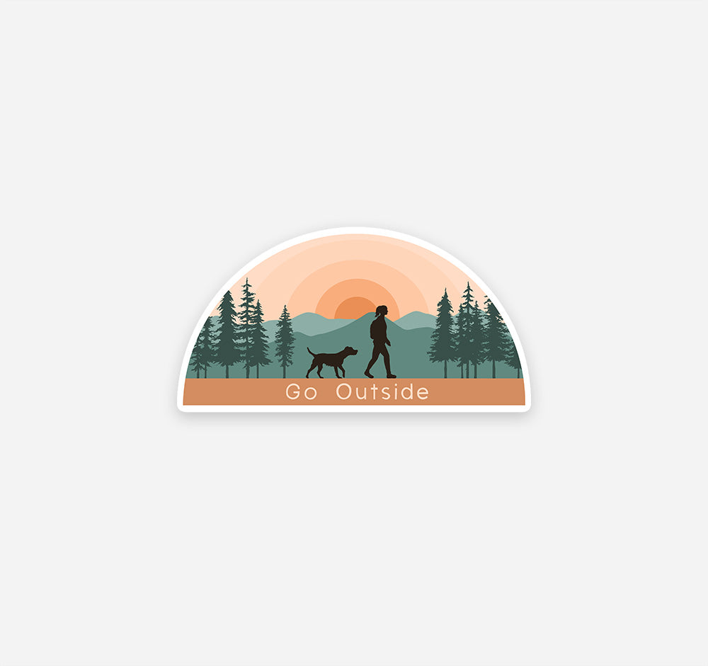 Hiking sticker of a girl and dog at sunset in the mountains