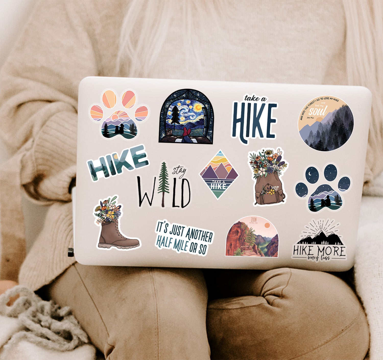 Hiking, camping, and adventure stickers on a laptop cover