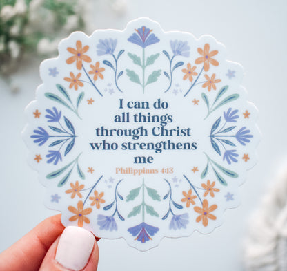 Decorative Christian faith sticker with the Bible verse "I can do all things through Christ who strengthens me, Philippians 4:13" surrounded by hand-drawn purple and orange flowers.