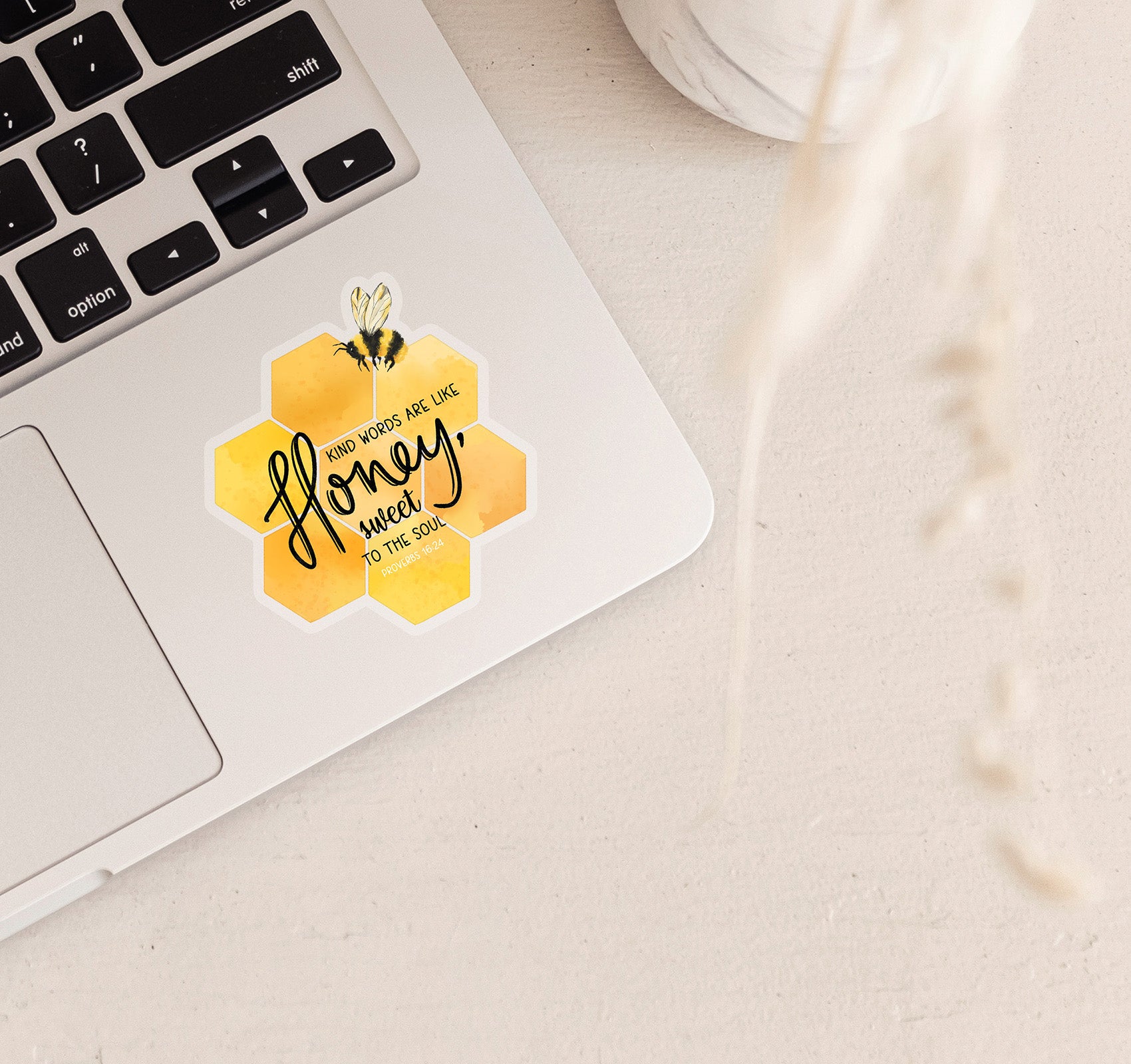 Kind words are like honey, sweet to the soul. This Proverbs 16:24 Bible verse Christian laptop sticker has a honeycomb and bumble bee