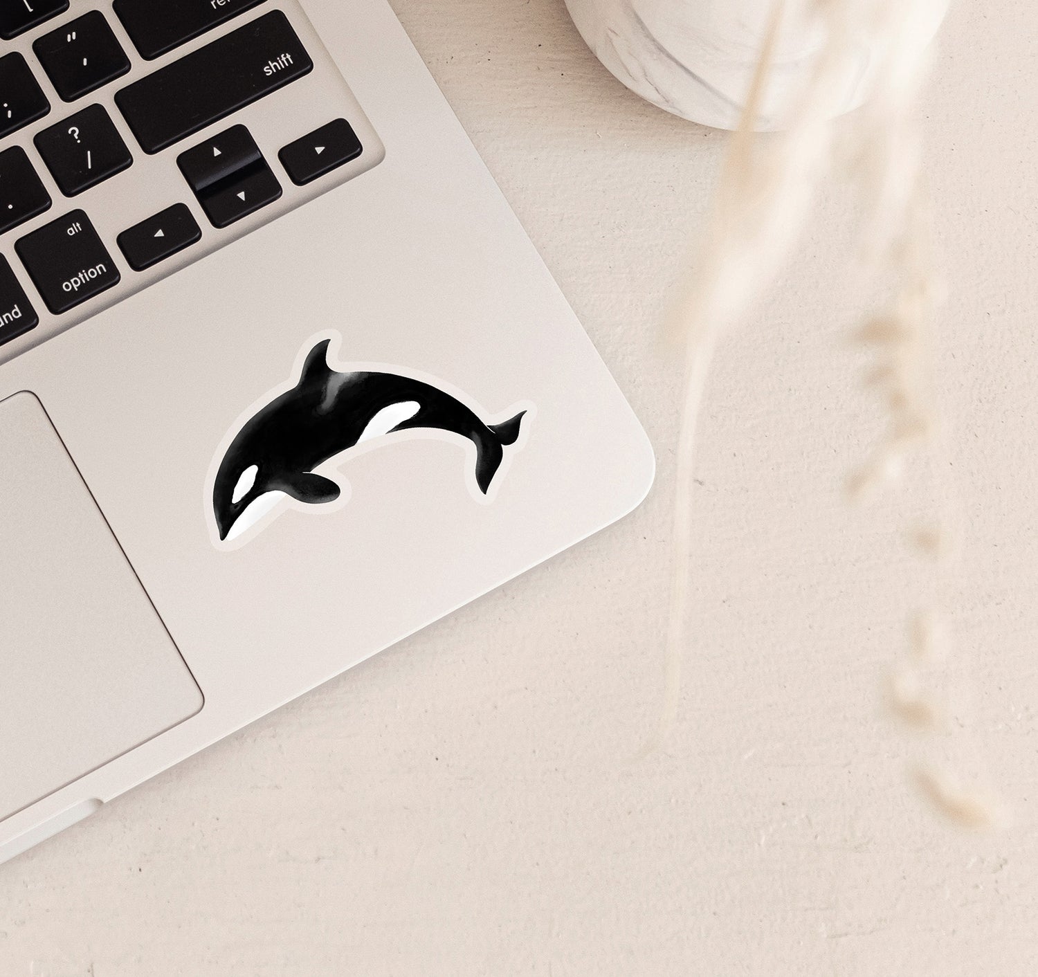 Clear vinyl ocean inspired laptop sticker of an orca whale, also known as a killer whale