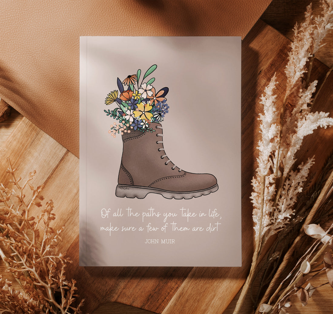John Muir quote journal with a hiking boot full of flowers