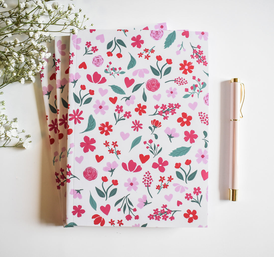 Journal with pink and red flowers on a light pink background