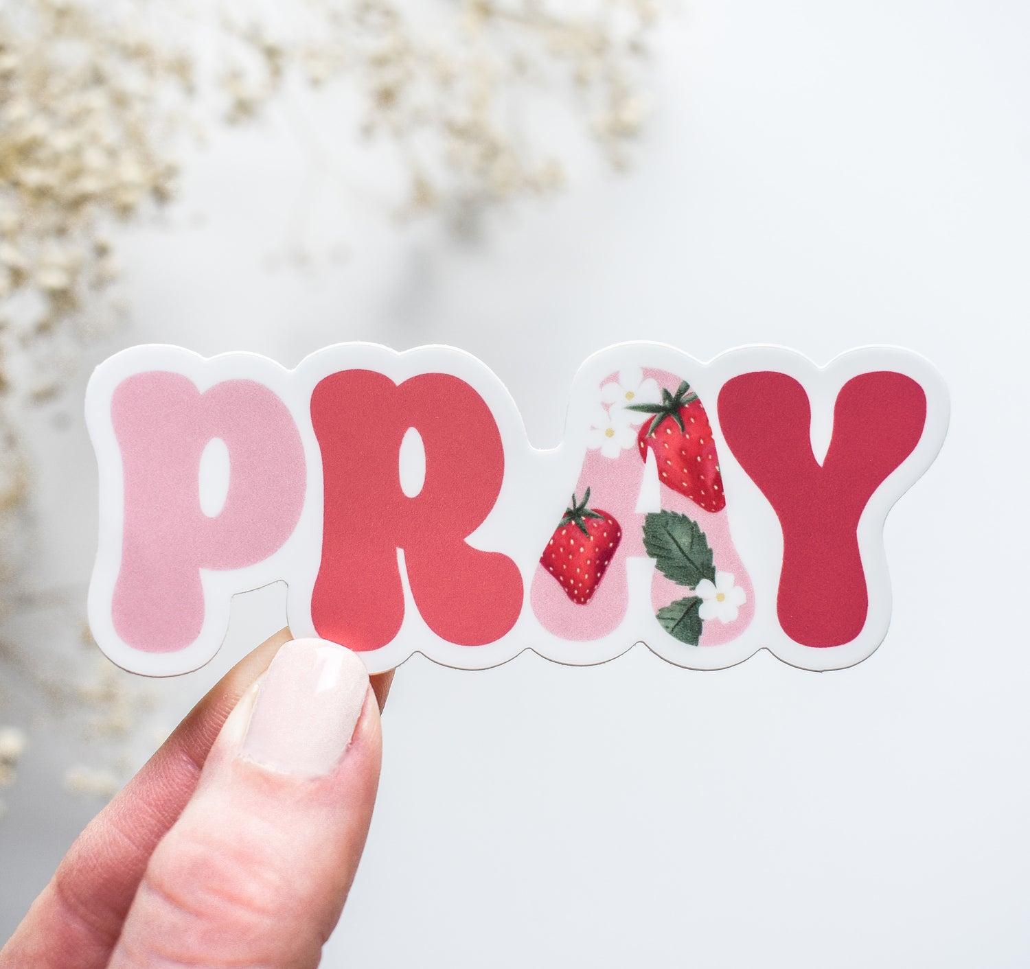 Pink PRAY vinyl sticker with a strawberry design