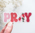 Pink PRAY vinyl sticker with a strawberry design