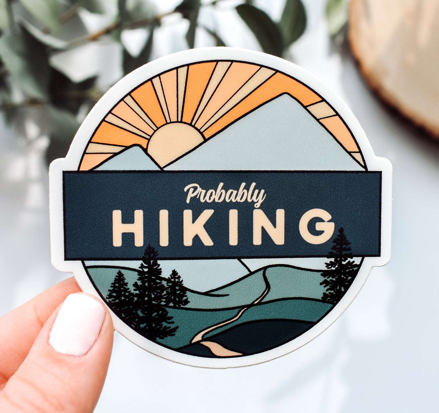 Mountain sticker with a trail, pine trees, and a sunset with the phrase &quot;probably hiking&quot;