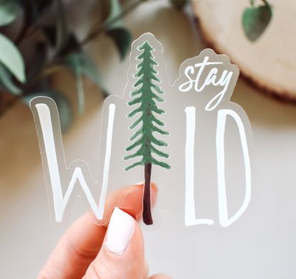 Stay Wild hiking sticker with a pine tree and white text on clear vinyl