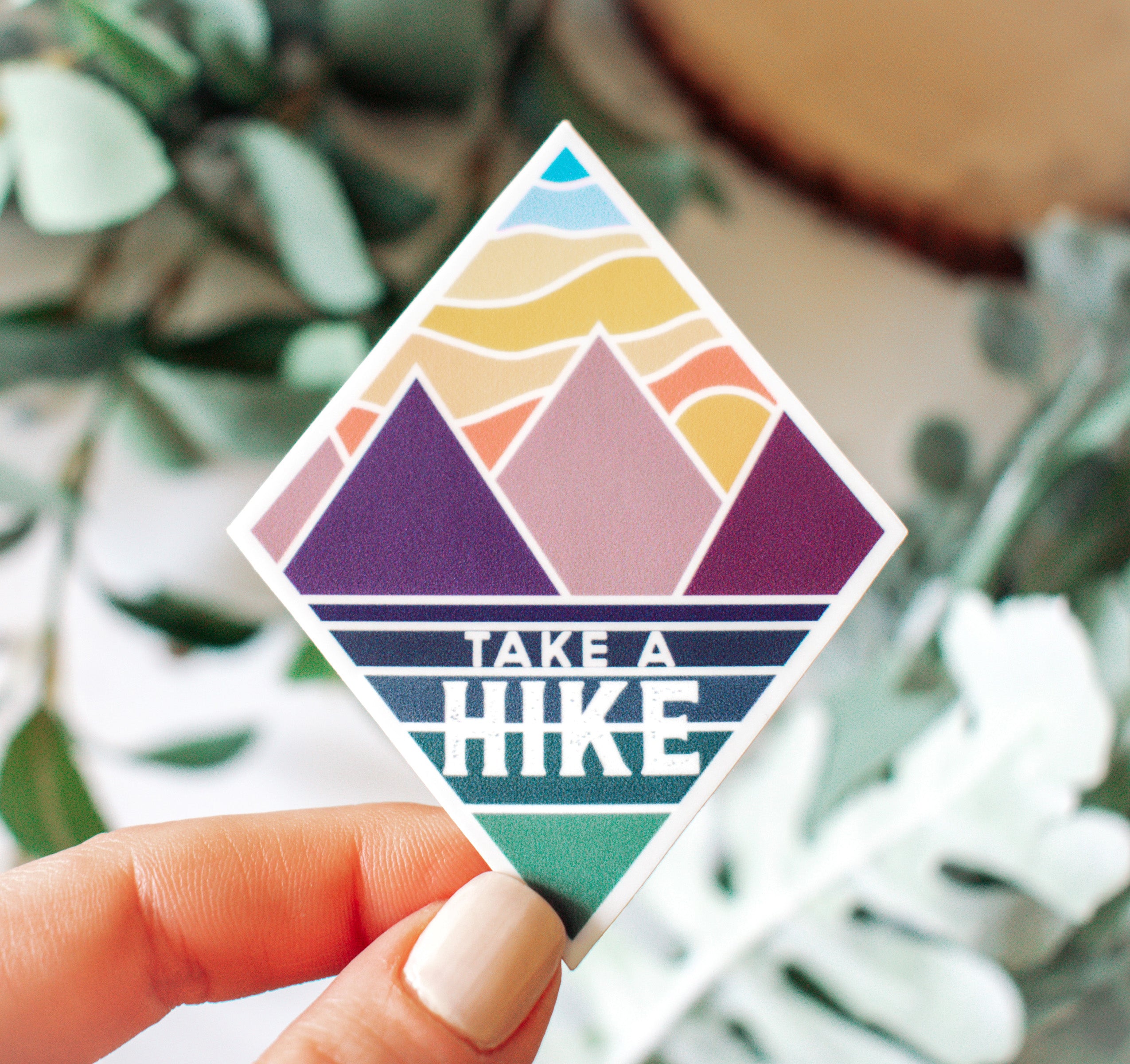 Take a hike sticker with mountains at sunset