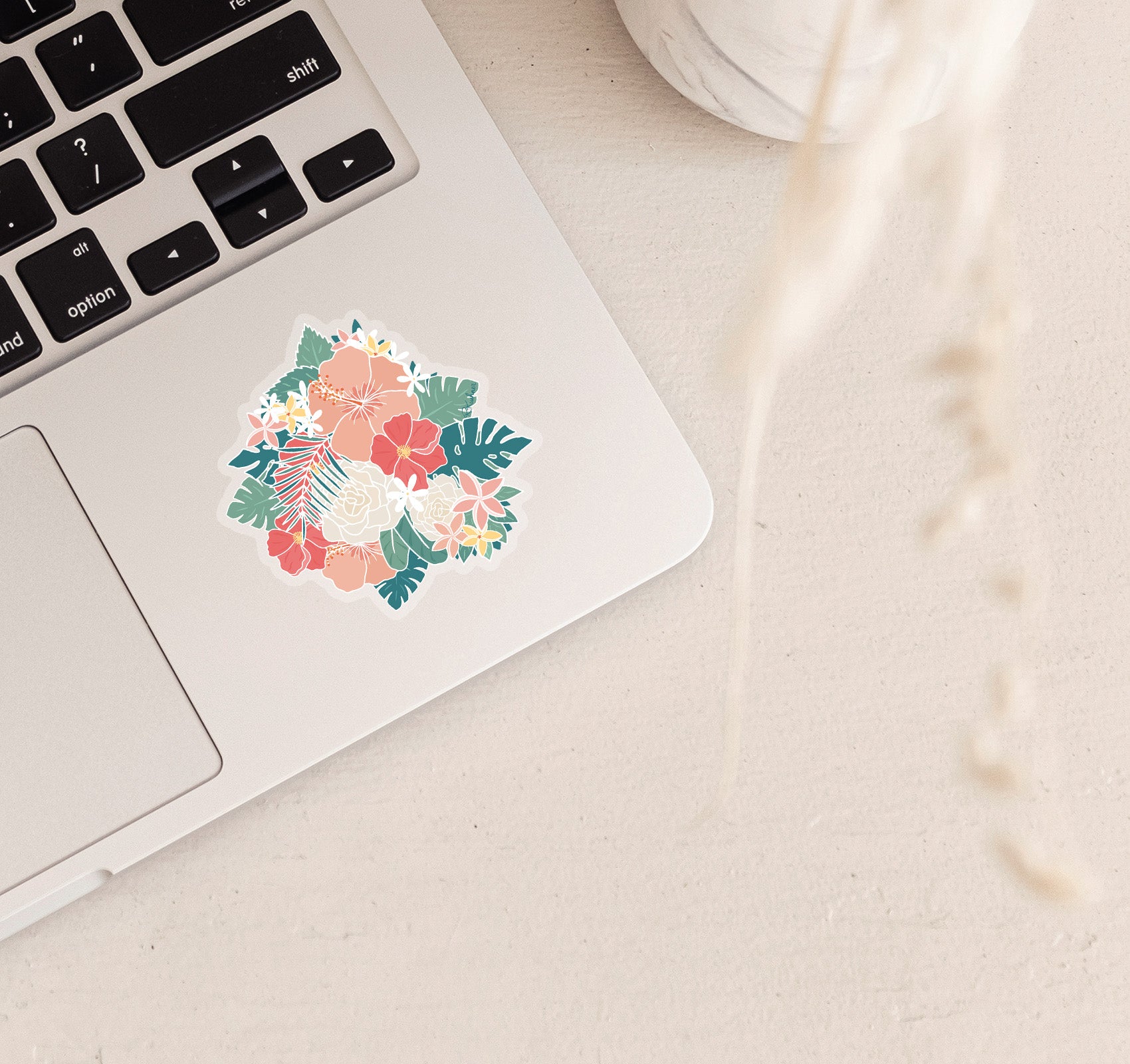 Tropical flowers laptop sticker including hibiscus flowers, plumeria, and monstera leaves