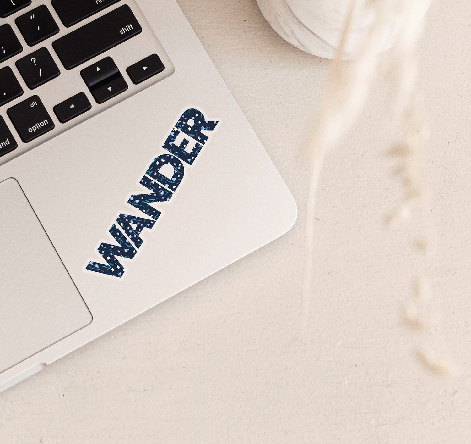 Wander laptop decal with a blue floral pattern