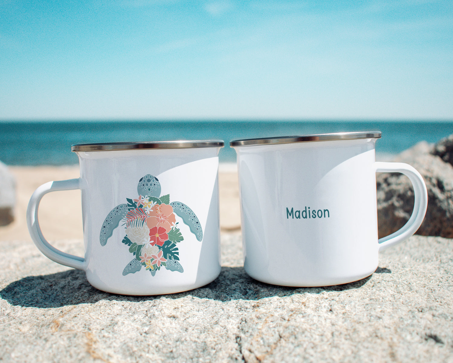 A Hawiian green sea turtle with tropical flowers shell on a metal camp mug